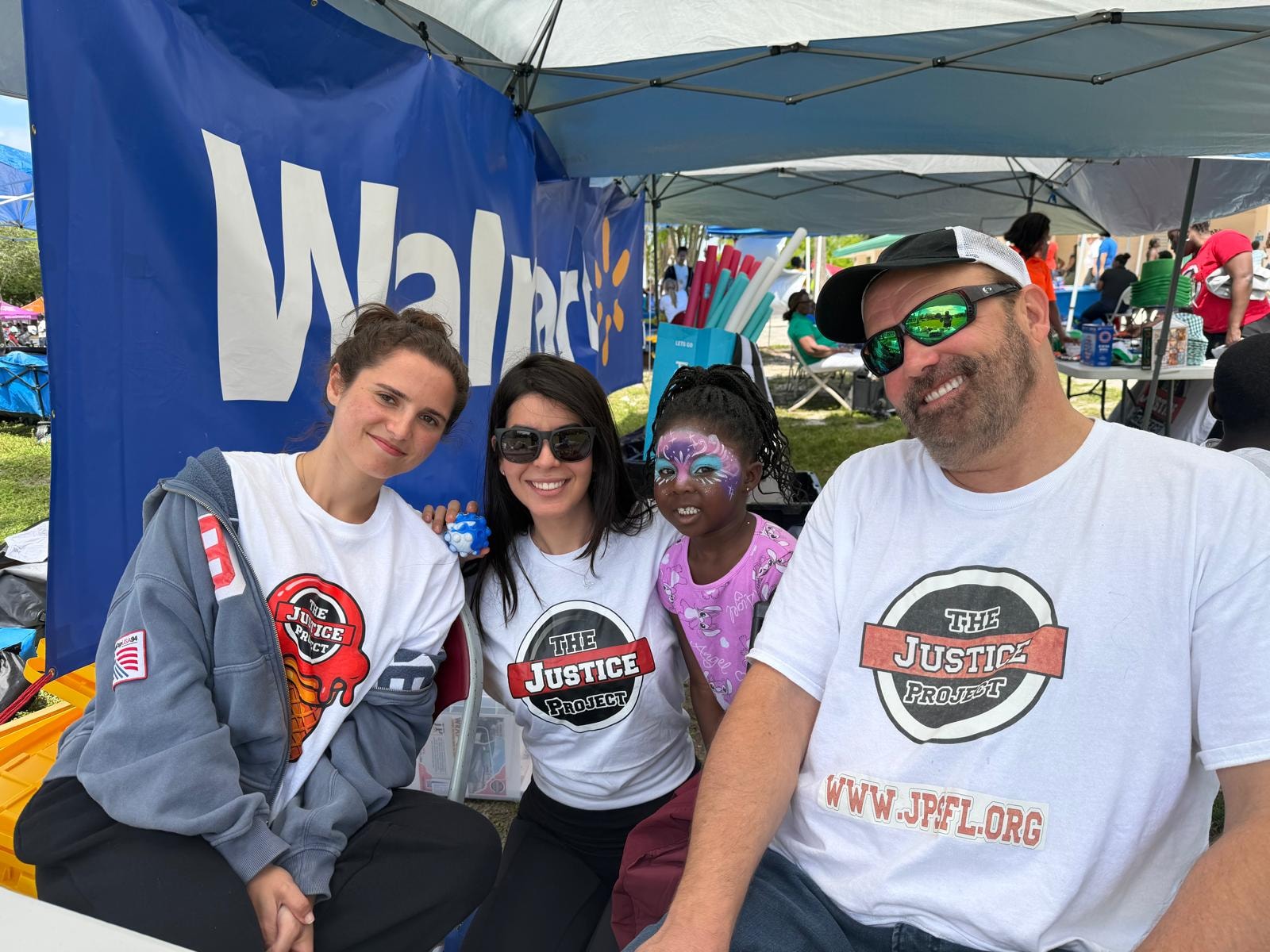 Philip Johnston, Jennifer Sherman, family, and friends volunteering with The Justice Project at a South Florida community event
